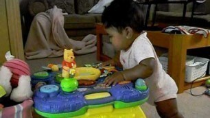 '6 month old baby playing'