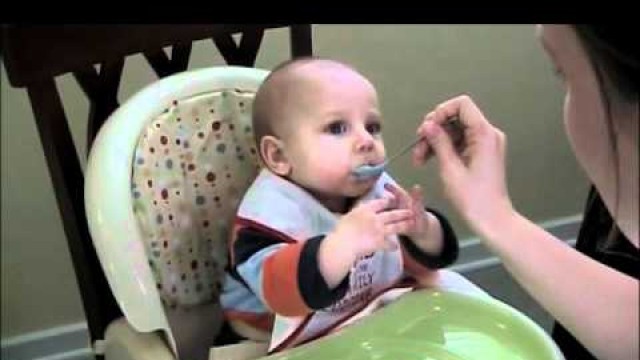 'Happy 6 months old baby eating for the first time!'