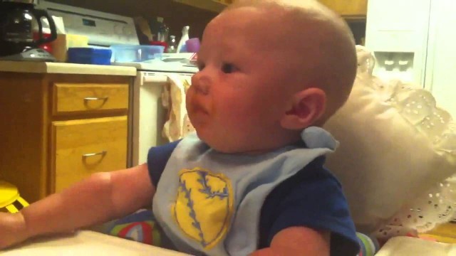 'Oliver 6 month old. Eating baby food for the first time'