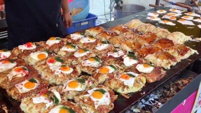 'Japanese street food | Okonomiyaki with cheese in Nagasaki city, Japan'