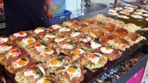 'Japanese street food | Okonomiyaki with cheese in Nagasaki city, Japan'