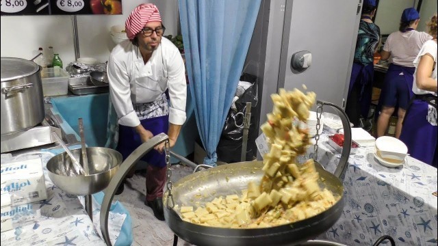 'Acrobatic Huge Pan with Italian Pasta \'Paccheri\', Pepper and Codfish. Italian Street Food'